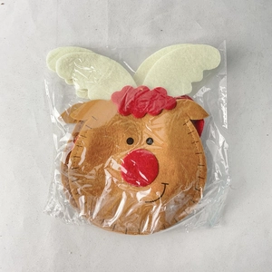 Close-up of reindeer felt Christmas candy bag with red nose detail in packaging