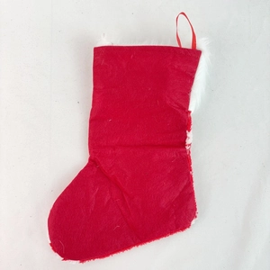 Close-up of red Christmas stocking with plush white trim and hanging rope for holiday decor
