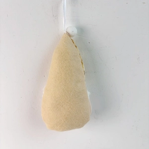 Close-up of beige teardrop felt ornament with silk rope and white bead detail