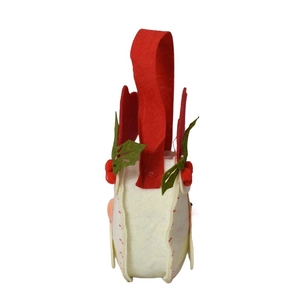 Felt Christmas candy bag with holly leaf decoration and red handles on white background