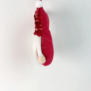 Detail of a Christmas gnome ornament featuring red sequins and white faux fur beard
