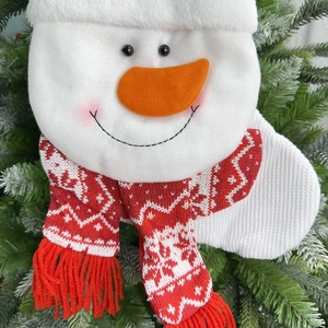 Detailed view of plush snowman Christmas stocking with red knit scarf and soft white fabric