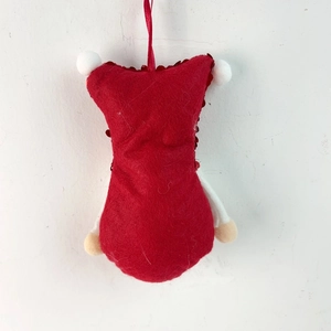 Detail of red felt Christmas gnome ornament with sequins and a soft hanging ribbon cord