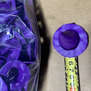 Detailed view of mini purple wizard hats for DIY crafts with measurement tape scale