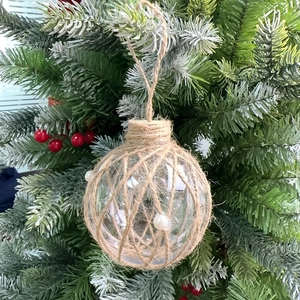 Detail of 8cm champagne Christmas ball wrapped in jute rope with white pearl accents