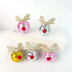 Close-up of glittery reindeer antlers on mirror disco ball Christmas tree ornaments