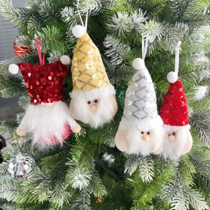 Set of four sequin Christmas gnome ornaments hanging on green holiday tree branches