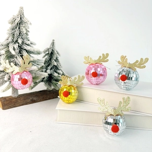 Close-up of reindeer disco ball ornaments in pink, gold, and silver for Christmas decor