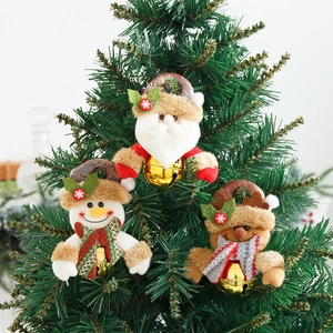 Detail of plush Santa, Snowman and Reindeer ornaments with golden bells on Christmas tree