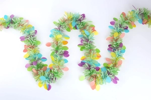 Detail of colorful Easter egg garland featuring striped tinsel and pastel macaron egg accents