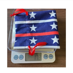 Detailed view of patriotic wine bag weight on scale, showing stars and stripes texture