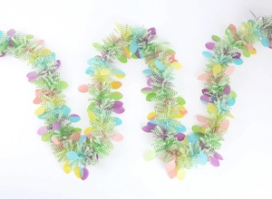 Close-up of fluffy green and white Easter tinsel garland with colorful egg sequins