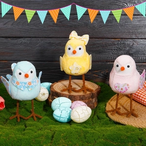 Three colorful plush Easter chicks with unique patterns on artificial green moss decor