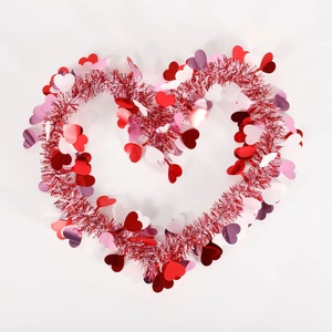 Detailed view of heart-shaped garland with red and pink sequins for festive decoration