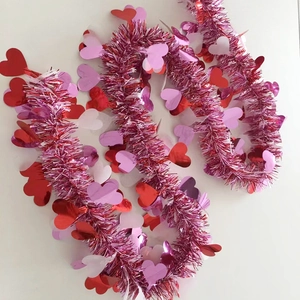 Sparkly tinsel garland with metallic pink and red hearts for Valentine's Day party decor