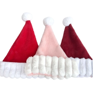 Thick plush Santa hats in red, pink, and burgundy with faux fur trim and white pom-poms