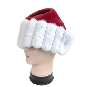Detailed view of plush red and white Christmas hat with thick faux fur on a white display