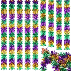 Close-up of fluffy purple, green and gold tinsel garlands for festive party decoration