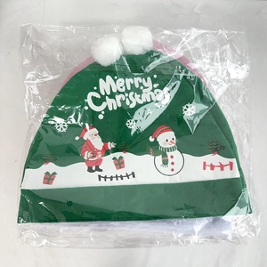 Close-up of green plush Christmas car seat cover with Merry Christmas print in packaging