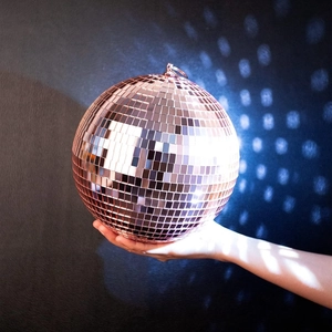 Close-up of rose gold disco mirror ball with square glass tiles and hanging ring