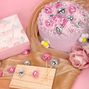 Pink and silver disco mirror ball cake toppers on wooden sticks for party decoration