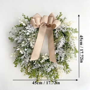 Detail view of artificial green wreath with a burlap bow showing 45cm diameter size