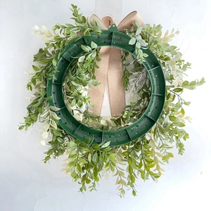 Detail of the plastic support ring and linen bow on the back of the green wreath