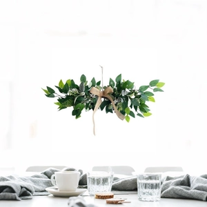 Artificial greenery garland with burlap bow for wedding arch and table decor