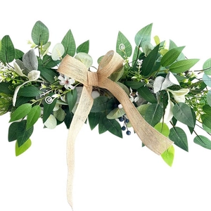 Artificial farmhouse greenery swag with burlap bow for wedding arch and home wall decor