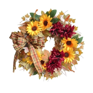 Autumn wreath with sunflowers, maple leaves, and a plaid bow for home door decoration
