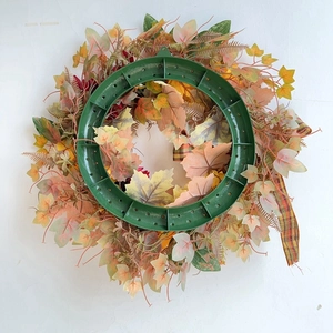 Detail view of the durable green plastic base and fall foliage of the autumn wreath