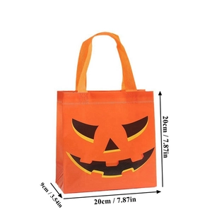 Close-up of orange non-woven Halloween pumpkin gift bag with 20x20x9cm size marks