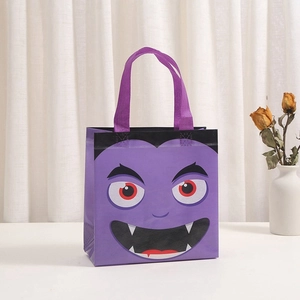 Close-up of a purple Halloween non-woven gift bag featuring a cartoon vampire face print