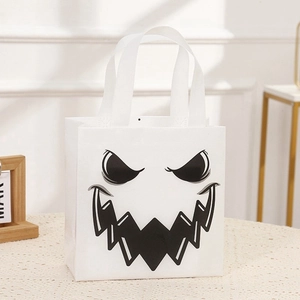 Macro shot of Halloween ghost face print on white non-woven gift bag for parties