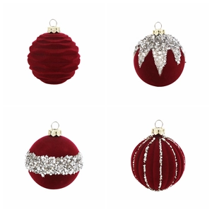Detail of four dark red velvet Christmas balls with glitter patterns and silver hooks