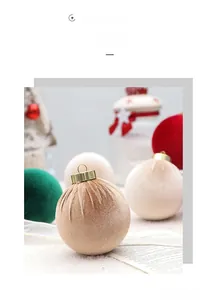 Detailed close-up of premium velvet Christmas balls with golden metal hanging caps