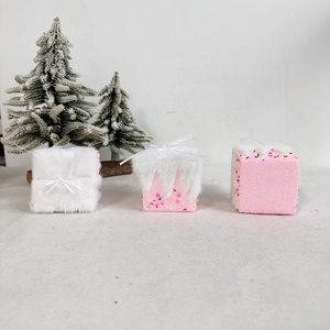 Three pink macaron style Christmas ornaments with white plush faux fur and ribbon details
