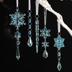 5-piece set of blue acrylic snowflake and icicle ornaments hanging on white branches