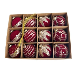Macro detail of 12-piece burgundy flocked Christmas ornaments with gold glitter patterns