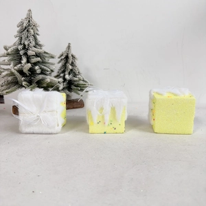Three yellow glitter Christmas gift box ornaments with snow tops and white ribbon bows