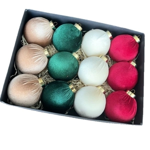 Close-up of luxury velvet Christmas balls set in premium gift box with paper shreds