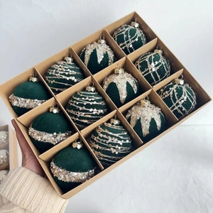 Macro shot of 12-piece dark green flocked Christmas balls with gold glitter star patterns