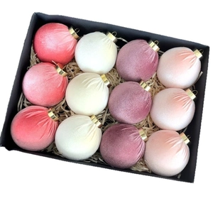 Set of twelve luxury velvet Christmas ornaments in Morandi colors displayed in a premium gift box