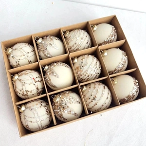Set of 12 ivory Christmas baubles with gold glitter stars in a grid gift box