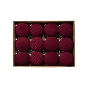 Macro view of burgundy flocked Christmas balls with assorted textures in a craft gift box