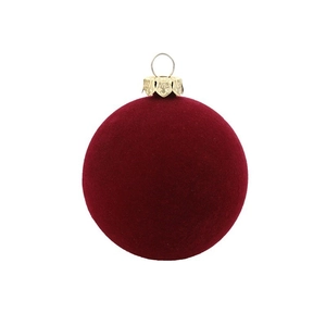 Detail of burgundy flocked velvet Christmas ornament with decorative gold metal cap and loop