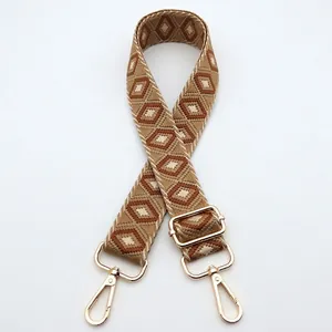 Adjustable woven shoulder strap with geometric diamond patterns and gold metal hooks