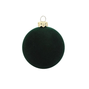 Close-up of dark green flocked Christmas ball with ornate gold cap and silver loop
