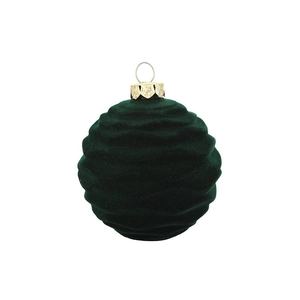 Macro detail of dark green flocked Christmas ball with gold metal cap and wave texture