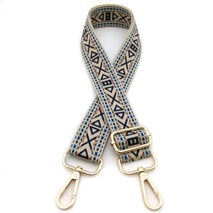 Detail of bohemian jacquard embroidered bag strap with gold metal buckles and hardware